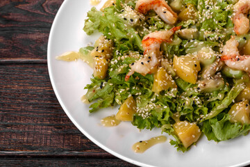 Delicious fresh salad with shrimp and pear for the festive table
