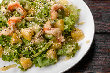 Delicious fresh salad with shrimp and pear for the festive table