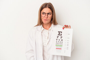 Young optometrist Russian woman isolated on white background confused, feels doubtful and unsure.