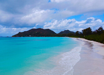 Aerial view of a beautiful beach with emerald water and white sand in the Seychelles.