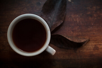 closeup photo of cup of black coffee on a rustic table - 459323364