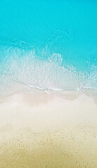 Top view of the beautiful ocean shore with waves and foam on the sand. Seychelles. Texture and background tourism design