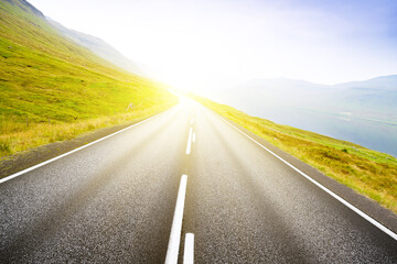Asphalt road along the sea. Country houses.