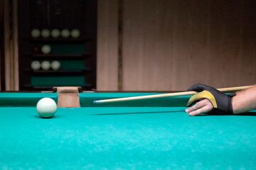 Playing billiards close-up. Billiard table, cue, billiard balls, cloth