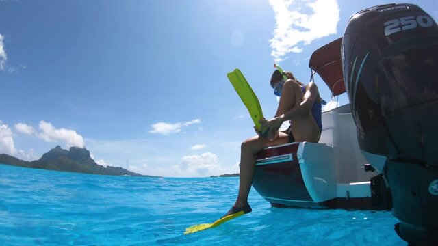 Snorkel diving excursion boat tour from yacht luxury travel influencer going swimming in coral reefs of Tahiti, French Polynesia Bora Bora island