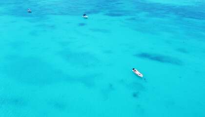 Top view of the gorgeous emerald clear ocean water in the Seychelles. Boats on the water