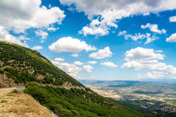 Fototapeta na wymiar Green hill under a cloudy sky in Sardinia