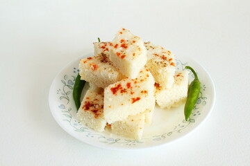 Indian gujarati Traditional Food white Dhokla snack also known as khaman in white background top view and copy space