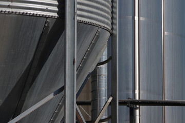 Close-up partial view of big metal storage tank silos