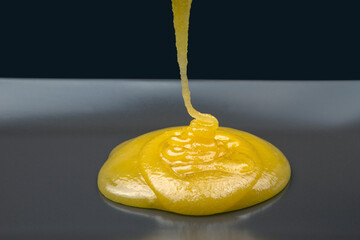 Fresh viscous floral honey flows onto the plate. vitamin organic food