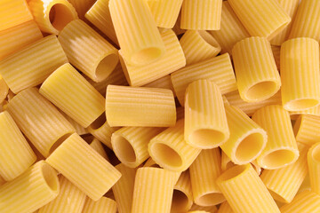 Italian Macaroni Pasta half sleeves striped raw food background or texture close up. Closeup of traditional raw italian pasta.