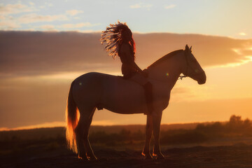An Indian and a horse at sunset