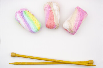 Yarn. Yarn for knitting. The colors of the rainbow. Woolen threads. Knitting needles for knitting in balls of thread.