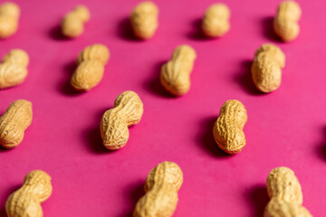 Peanut pattern on pink background. Flat lay.