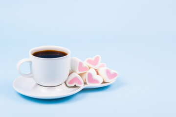 Espresso and marshmallows on blank blue photo