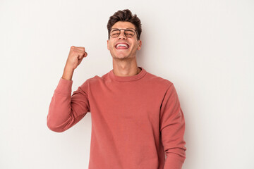 Fototapeta premium Young caucasian man isolated on white background celebrating a victory, passion and enthusiasm, happy expression.