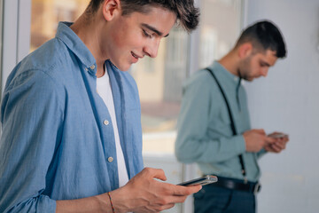 Fototapeta premium young people looking at the mobile phone