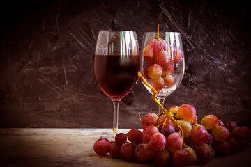 red wine glass, fresh grapes on concrete background
