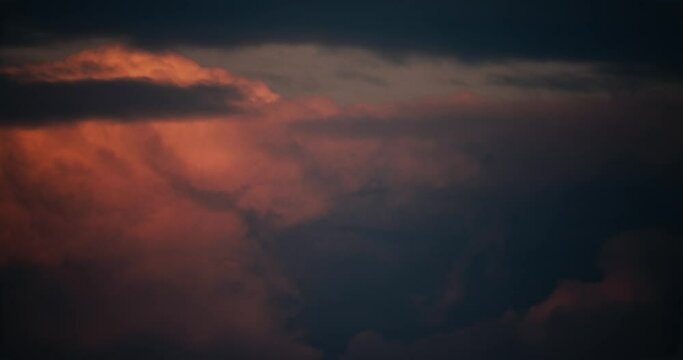 The movement of cumulus clouds at sunset from the midst of rain clouds. Timelapse video.