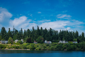2021-09-26 THE SHORELINE OF BAINBRIDEGE ISLAND FROM THE PUGET SOUND WITH A BRIGHT BLUE SK