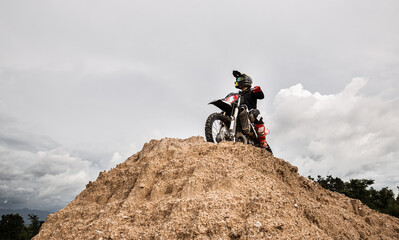 Motocross rider on his bike ready to race in dirt track