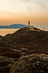 Lighthouse on the Coastline at Sunset in Mykonos Greece