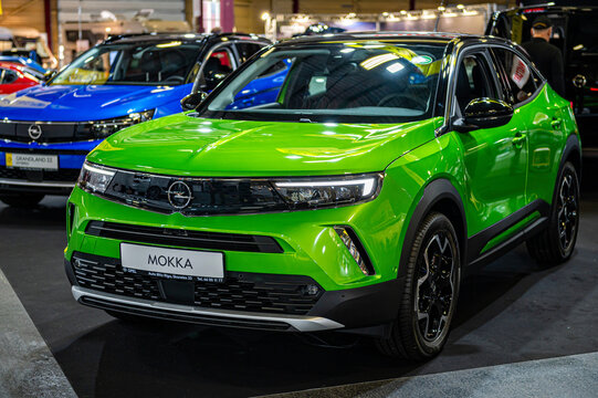 green electric vehicle Opel Mokka-e premiere at a motor show, 2021 model, front view