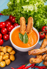 Tomato soup with crispy bread sticks. Vegetable cream soup
