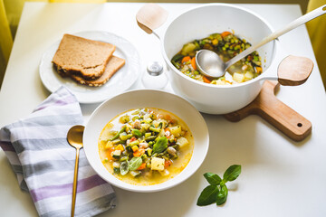 Top view of vegetable soup minestrone served in a plate on dining table at the kitchen