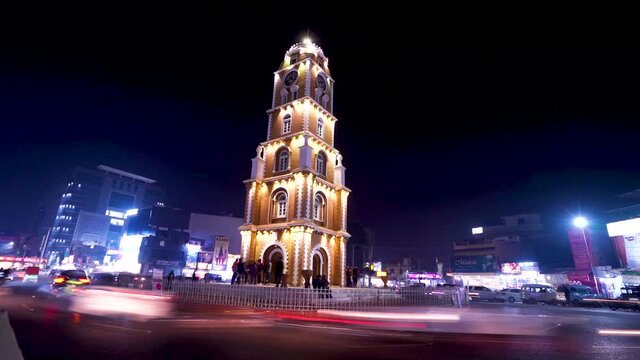 silhouette long shot of historic building of clock tower with lights in Sialkot in Punjab Pakistan