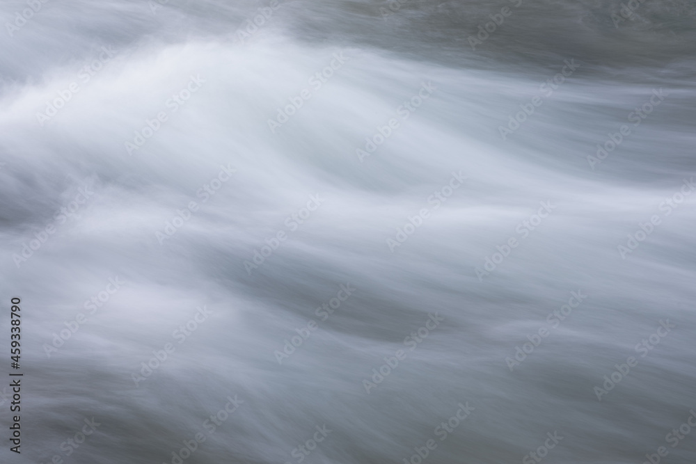 Poster abstract background from long exposure of water stream in a mountain river close-up