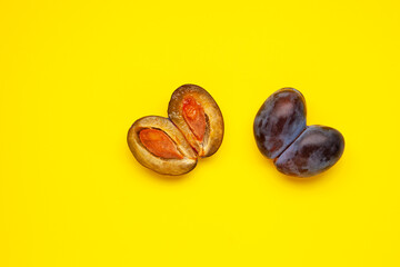 Ugly plum, shaped heart.  The fused fruit in the section. Ugly vegetables and fruits are suitable for food. Concept - Reduction of organic food waste