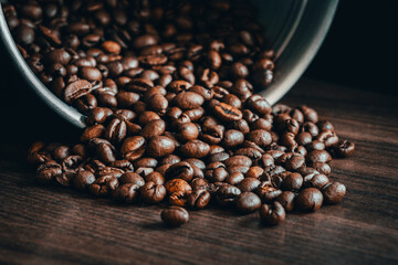 Portafilter coffee with tamper on dark woodden surface