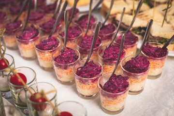 Catering table buffet dinner, beautifully decorated banquet with variety of different food snacks and appetizers on corporate birthday party event or wedding reception, canape, delicatessen setting