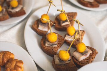 Catering table buffet dinner, beautifully decorated banquet with variety of different food snacks and appetizers on corporate birthday party event or wedding reception, canape, delicatessen setting