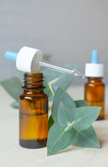 Eucalyptus oil in glass bottle and eucalyptus leaves