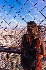 Tourist contemplating Paris from the Eiffel tower