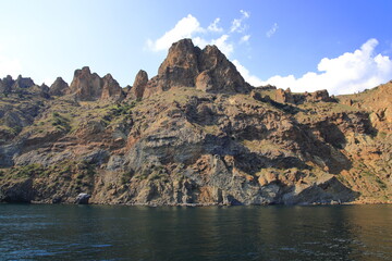 The cliffs of a high mountain on the seashore, calm and clear weather. Suitable for backgrounds, photo wallpapers and landscape lovers.