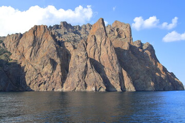 The cliffs of a high mountain on the seashore, calm and clear weather. Suitable for backgrounds, photo wallpapers and landscape lovers.