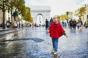 Happy preschooler girl walking in Champs-Elysees in Paris, France