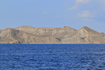 The seashore in sunny weather, a view of the cape and a calm sea. Suitable for photo wallpapers, photo frames and lovers of water landscapes.