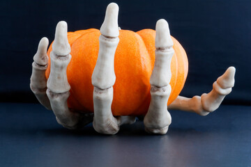 skeleton hand and orange pumpkin 2