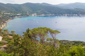 Fototapeta na wymiar Western part of the little peninsula of Monte Enfola in Elba island in Italy with its nice big open bay 