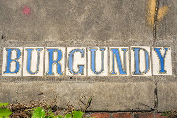 Burgundy Street Tile Inlay on Sidewalk in French Quarter in New Orleans, Louisiana, USA