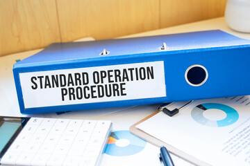 Standard Operation Procedure words on labels with document binders - obrazy, fototapety, plakaty