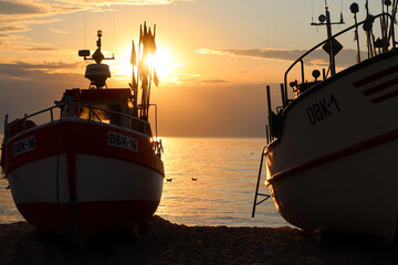 Fishing boats silhouettes. Boats docking on the beach. Summer evening on the beach