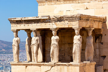 Ancient Erechtheion or Erechtheum temple with Caryatid Porch on the Acropolis, Athens, Greece. World famous landmark at the Acropolis Hill. - obrazy, fototapety, plakaty