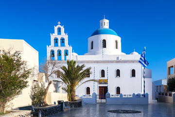Traditional greek orthodox church in the center of Oia village, Santorini island, Greece.