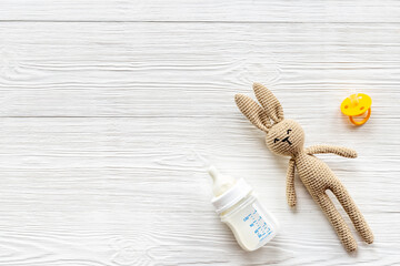 Fototapeta na wymiar Baby accessories with milk bottle and rabbit toy