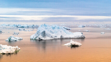 Arctic Icebergs Greenland in the arctic sea. You can easily see that iceberg is over the water...